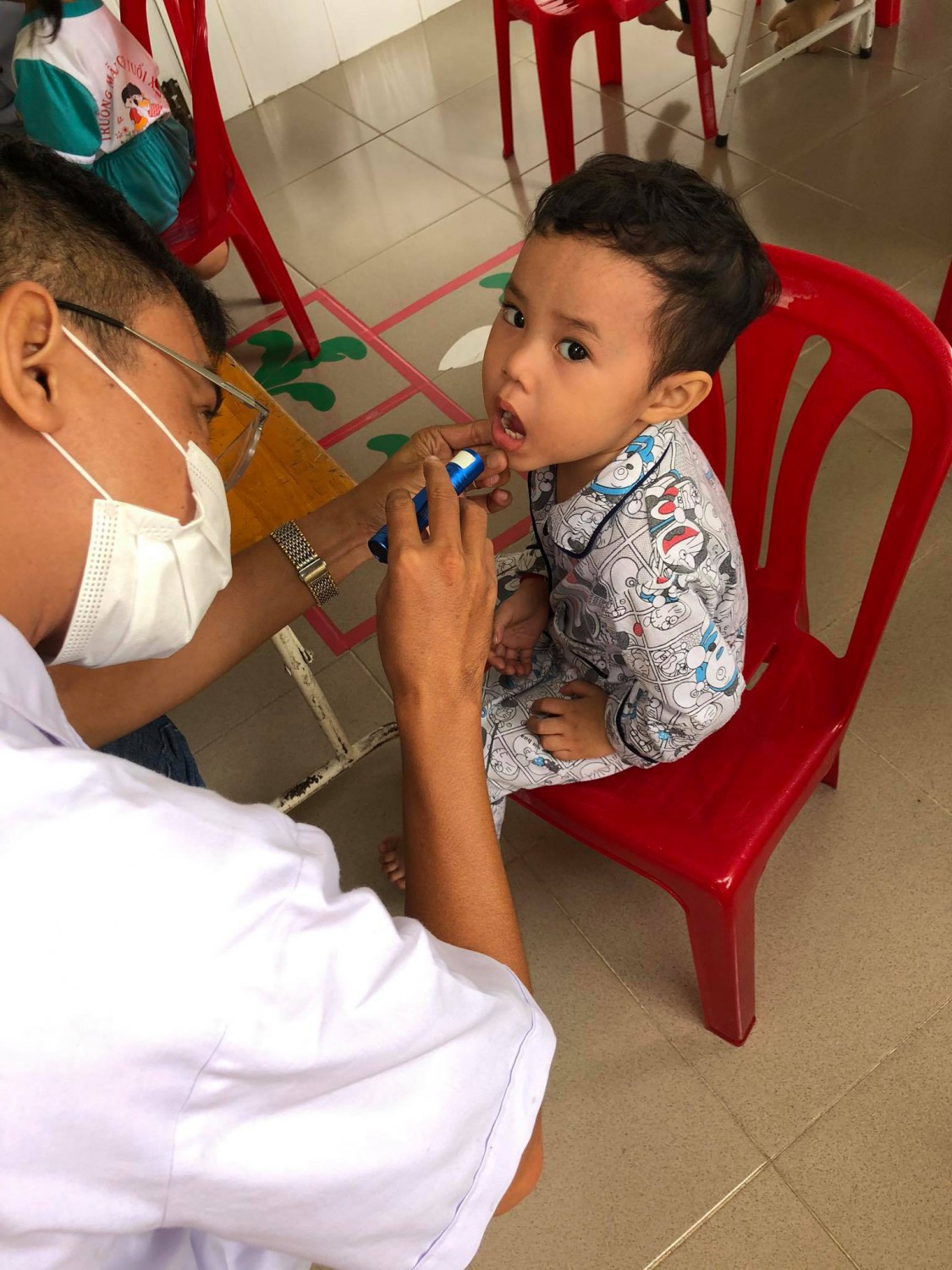 Bé được bác sĩ khám răng miệng
